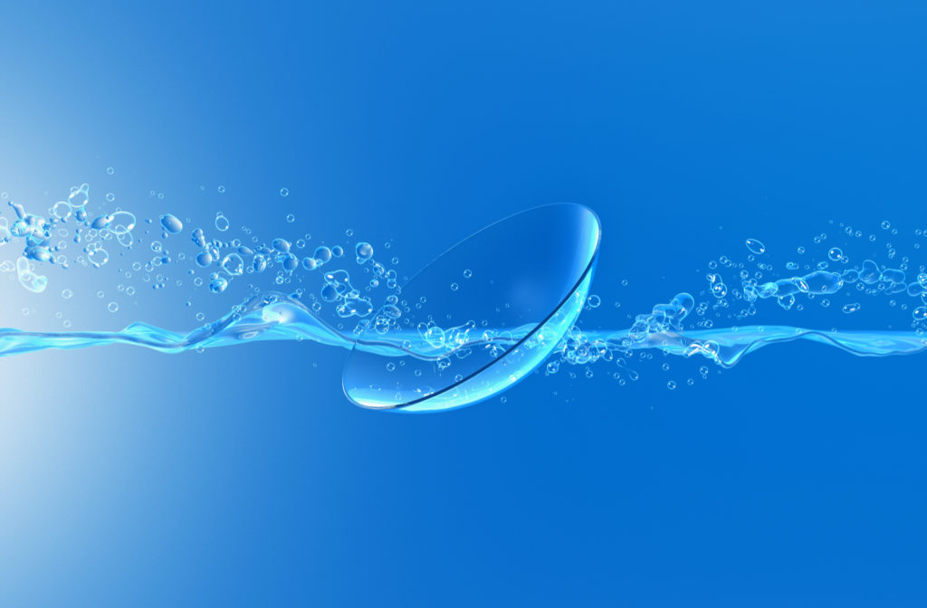 Contact lens being splashed by solution with blue background.
