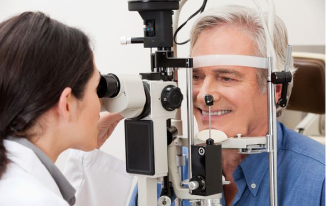 optometrist performing Visual Field Test on patient at eye clinic
