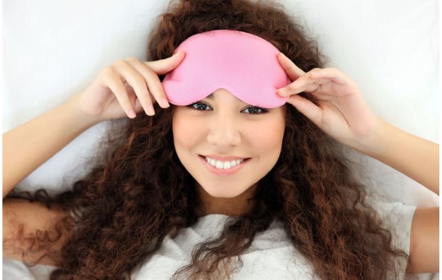 Young women laying in bed with eye mask to help with dry eye
