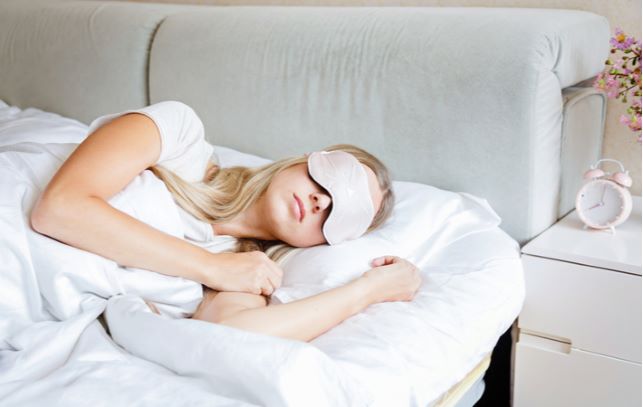 Women sleeping while wearing eye mask to help with her dry eye