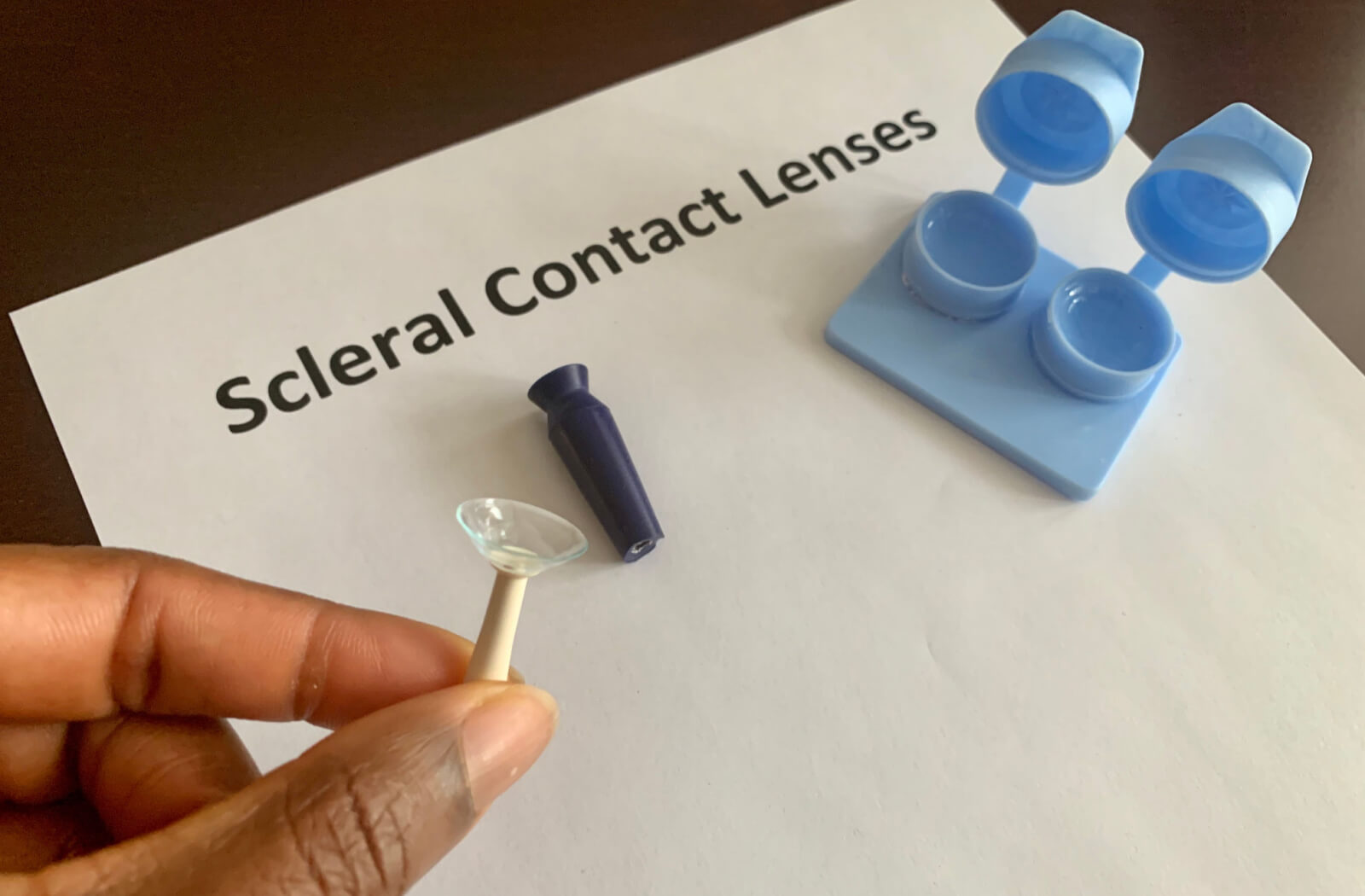 A contact lens case with scleral contacts and a contact lens insertion and removal kit.