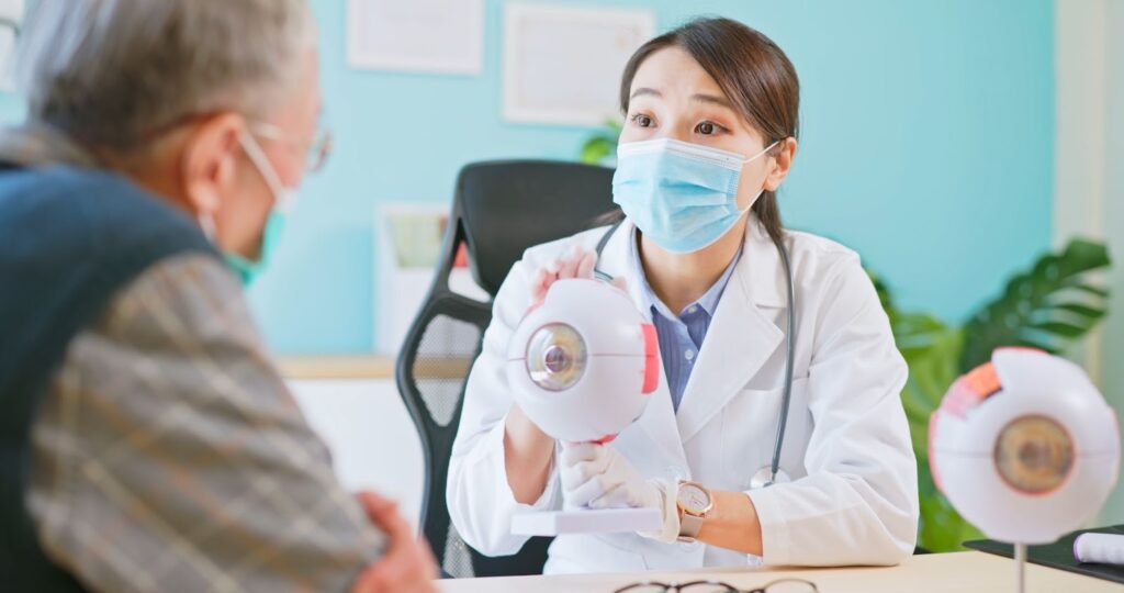 Here's a recommended change: An optometrist explains glaucoma to a patient using a 3D model of the eye.